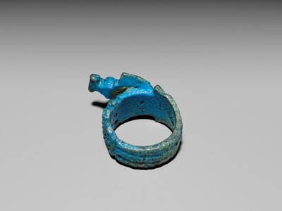 Lot 46 - A RARE TURQUOISE GLAZED FAIENCE RING WITH AEGIS OF NEPHTHYS, THIRD INTERMEDIATE PERIOD, DYNASTY XXII