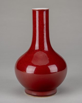 Lot 929 - A PORCELAIN ‘OXBLOOD’ GLAZED BOTTLE VASE, 19TH CENTURY