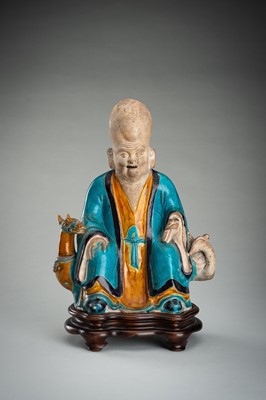 A FINE A FAHUA-GLAZED BISCUIT FIGURE OF SHOULAO, MING DYNASTY