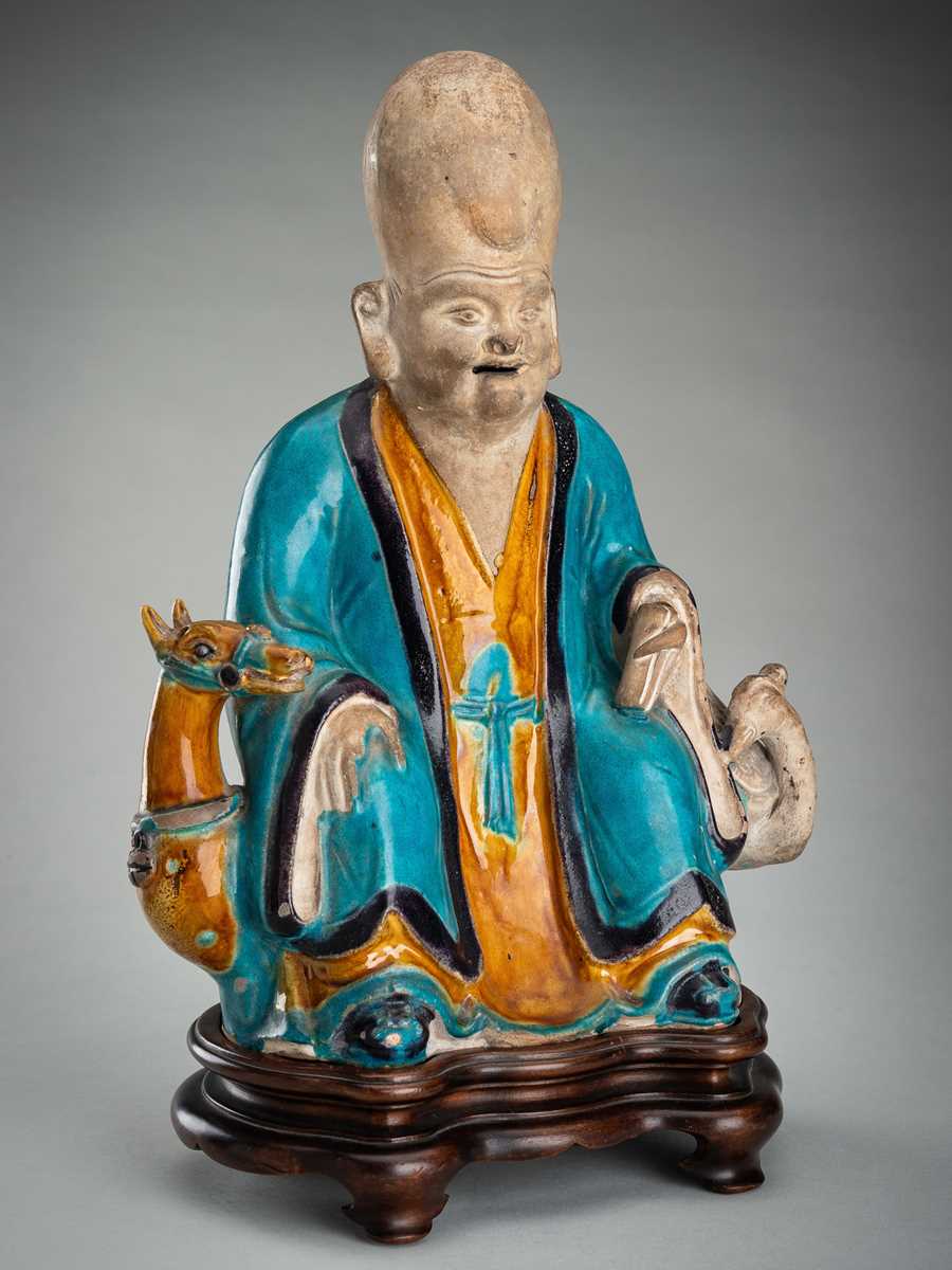 A FINE A FAHUA-GLAZED BISCUIT FIGURE OF SHOULAO, MING DYNASTY