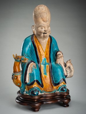 Lot 884 - A FINE A FAHUA-GLAZED BISCUIT FIGURE OF SHOULAO, MING DYNASTY