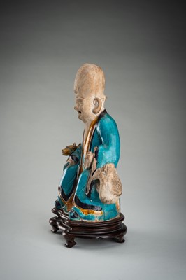 A FINE A FAHUA-GLAZED BISCUIT FIGURE OF SHOULAO, MING DYNASTY