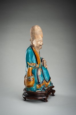 A FINE A FAHUA-GLAZED BISCUIT FIGURE OF SHOULAO, MING DYNASTY