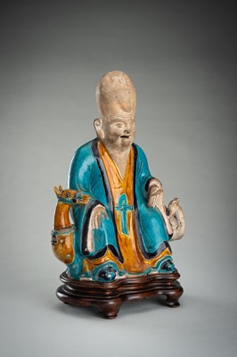 A FINE A FAHUA-GLAZED BISCUIT FIGURE OF SHOULAO, MING DYNASTY