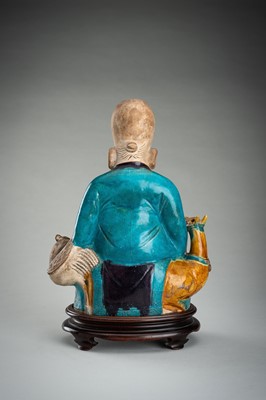 A FINE A FAHUA-GLAZED BISCUIT FIGURE OF SHOULAO, MING DYNASTY