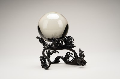 AN OKIMONO OF A ROCK CRYSTAL SPHERE ON A FINE BRONZE WAVE-FORM STAND