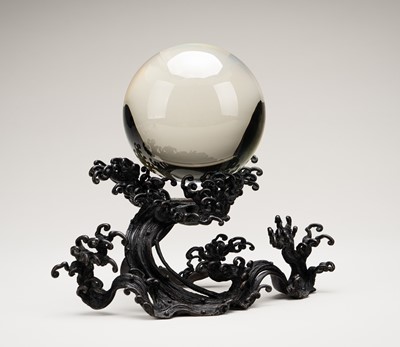 Lot 48 - AN OKIMONO OF A ROCK CRYSTAL SPHERE ON A FINE BRONZE WAVE-FORM STAND