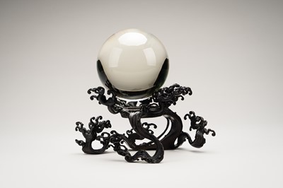 AN OKIMONO OF A ROCK CRYSTAL SPHERE ON A FINE BRONZE WAVE-FORM STAND