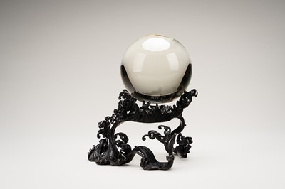 AN OKIMONO OF A ROCK CRYSTAL SPHERE ON A FINE BRONZE WAVE-FORM STAND