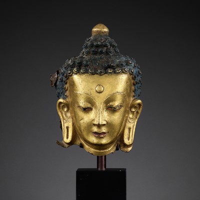 Lot 15 - A GILT COPPER REPOUSSÉ HEAD OF BUDDHA, 18TH CENTURY