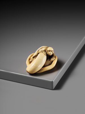 A SUPERB IVORY NETSUKE OF A MONKEY ON AN UPTURNED MUSHROOM, ATTRIBUTED TO OKATOMO