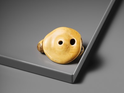 A SUPERB IVORY NETSUKE OF A MONKEY ON AN UPTURNED MUSHROOM, ATTRIBUTED TO OKATOMO