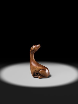 Lot 81 - A VERY RARE WOOD NETSUKE OF A SINIU
