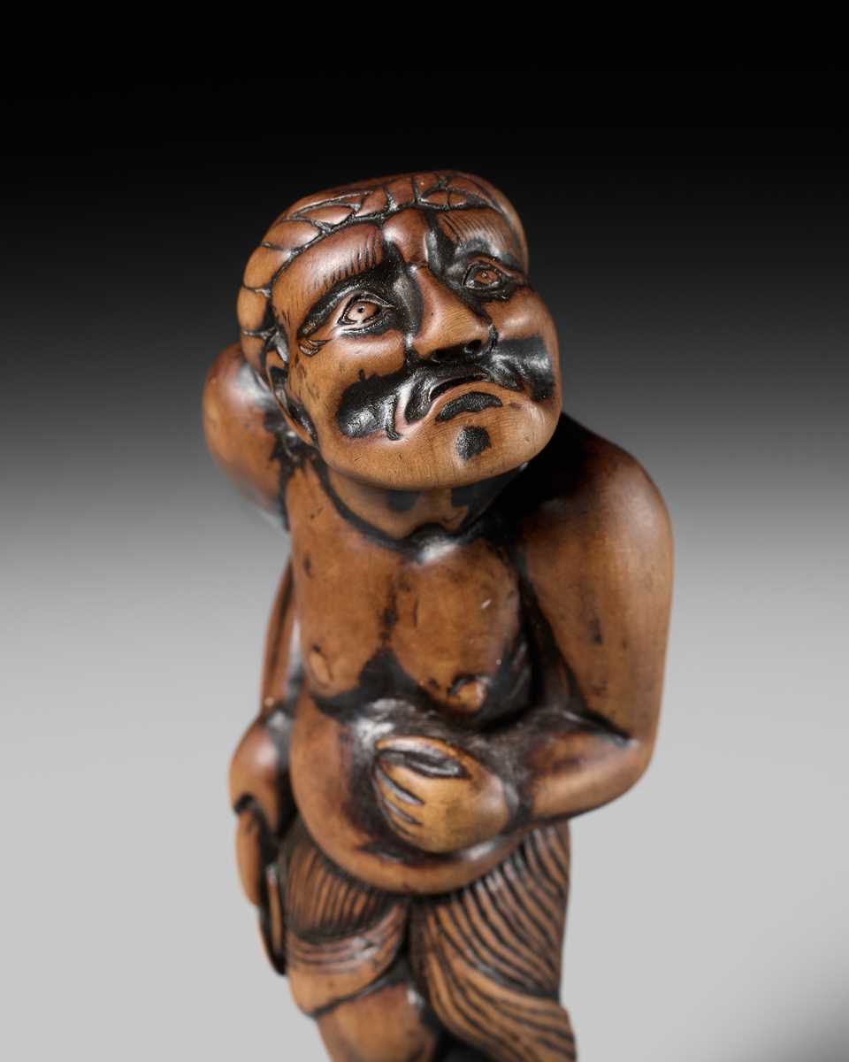 Lot 197 - A SUPERB AND LARGE EDO SCHOOL WOOD NETSUKE OF A DANCING MONEY LENDER