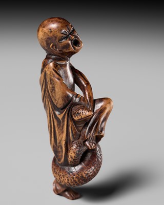 Lot 203 - KEISAI: A RARE EDO SCHOOL WOOD NETSUKE OF AN AGONISED MONK BATTLING A SNAKE