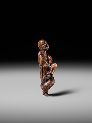 Lot 203 - KEISAI: A RARE EDO SCHOOL WOOD NETSUKE OF AN AGONISED MONK BATTLING A SNAKE