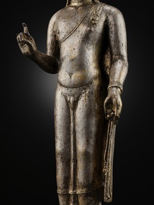 Lot 220 - A LARGE SILVER AND COPPER-ALLOY FIGURE OF BUDDHA SHAKYAMUNI, CENTRAL JAVA, CIRCA 9TH CENTURY