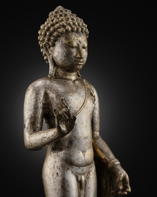 Lot 220 - A LARGE SILVER AND COPPER-ALLOY FIGURE OF BUDDHA SHAKYAMUNI, CENTRAL JAVA, CIRCA 9TH CENTURY