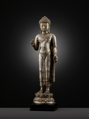 Lot 220 - A LARGE SILVER AND COPPER-ALLOY FIGURE OF BUDDHA SHAKYAMUNI, CENTRAL JAVA, CIRCA 9TH CENTURY