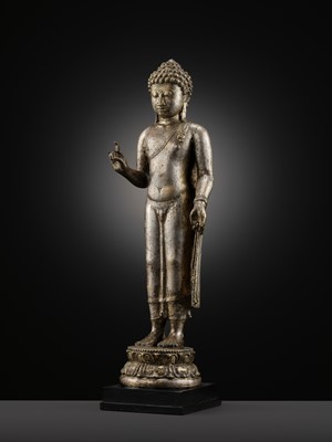 Lot 220 - A LARGE SILVER AND COPPER-ALLOY FIGURE OF BUDDHA SHAKYAMUNI, CENTRAL JAVA, CIRCA 9TH CENTURY