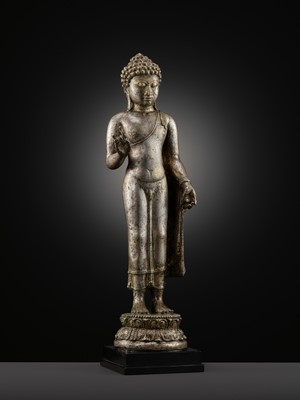 Lot 220 - A LARGE SILVER AND COPPER-ALLOY FIGURE OF BUDDHA SHAKYAMUNI, CENTRAL JAVA, CIRCA 9TH CENTURY