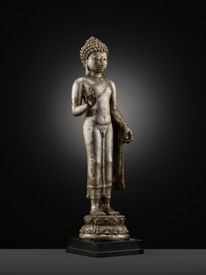 Lot 220 - A LARGE SILVER AND COPPER-ALLOY FIGURE OF BUDDHA SHAKYAMUNI, CENTRAL JAVA, CIRCA 9TH CENTURY