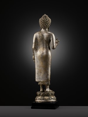 Lot 220 - A LARGE SILVER AND COPPER-ALLOY FIGURE OF BUDDHA SHAKYAMUNI, CENTRAL JAVA, CIRCA 9TH CENTURY