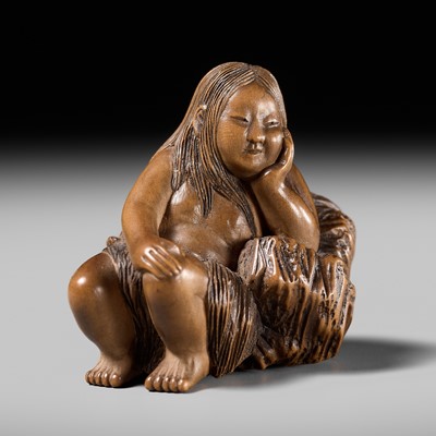 Lot 132 - MASAKATSU: A PALE WOOD NETSUKE OF A CLAM DIVER RESTING ROCKS