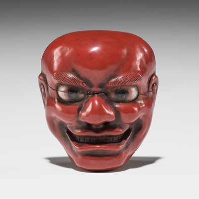 A TSUISHU (CARVED RED LACQUER) MASK NETSUKE OF A GRINNING MAN