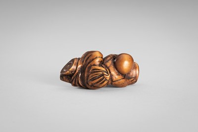 Lot 349 - A WOOD NETSUKE OF A BOY ON A BAMBOO LOG