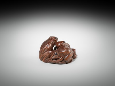 Lot 381 - SENKO: A WOOD NETSUKE OF FROGS AND LOTUS