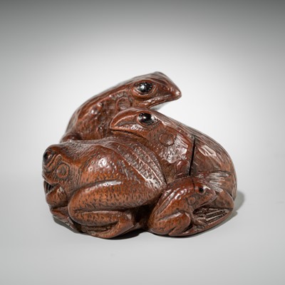 Lot 381 - SENKO: A WOOD NETSUKE OF FROGS AND LOTUS