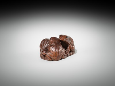 Lot 381 - SENKO: A WOOD NETSUKE OF FROGS AND LOTUS