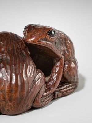 Lot 381 - SENKO: A WOOD NETSUKE OF FROGS AND LOTUS