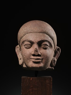 Lot 195 - A LARGE PINK SANDSTONE HEAD OF BUDDHA, MATHURA, KUSHAN PERIOD