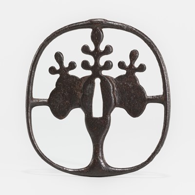 Lot 599 - AN IRON SUKASHI KUTSUWA (HORSE BIT) TSUBA WITH KIRI MON (PAULOWNIA CREST)