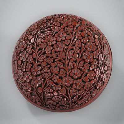 Lot 100 - A SMALL CARVED CINNABAR LACQUER ‘PRUNUS’ BOX AND COVER, 18TH CENTURY