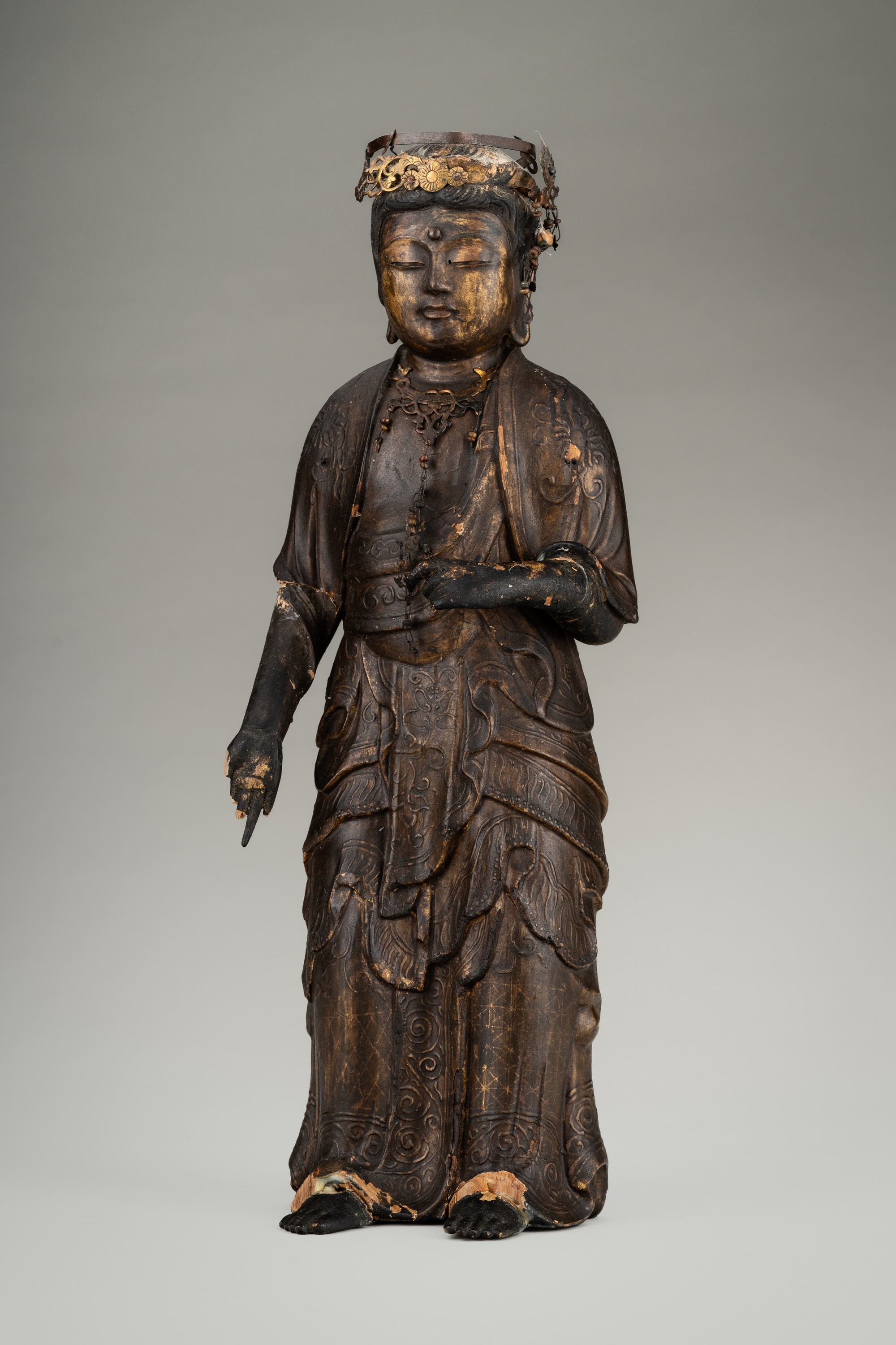 Lot 67 - AN OLD GILT AND LACQUERED WOOD FIGURE OF