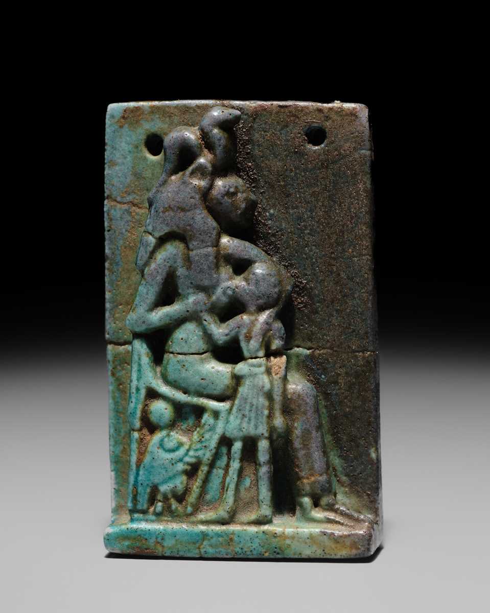 A TURQUOISE-GLAZED FAIENCE AMULET OF SEKHMET NURSING THE YOUNG PHARAOH, LATE PERIOD TO PTOLEMAIC ERA
