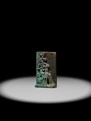 A TURQUOISE-GLAZED FAIENCE AMULET OF SEKHMET NURSING THE YOUNG PHARAOH, LATE PERIOD TO PTOLEMAIC ERA