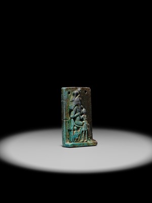 A TURQUOISE-GLAZED FAIENCE AMULET OF SEKHMET NURSING THE YOUNG PHARAOH, LATE PERIOD TO PTOLEMAIC ERA