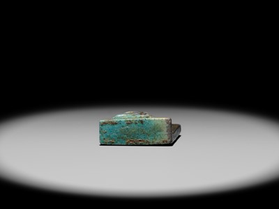 A TURQUOISE-GLAZED FAIENCE AMULET OF SEKHMET NURSING THE YOUNG PHARAOH, LATE PERIOD TO PTOLEMAIC ERA