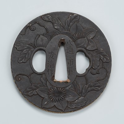 Lot 1558 - TOMOKIYO: A CHOSHU SCHOOL IRON TSUBA WITH FLORAL MOTIFS