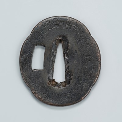 Lot 1459 - A BRONZE KAGAMISHI TSUBA WITH SCROLLING TENDRILS, FOLIAGE, AND PRUNUS