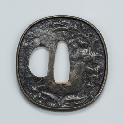 Lot 1460 - A BRONZE KAGAMISHI TSUBA WITH SCROLLING TENDRILS