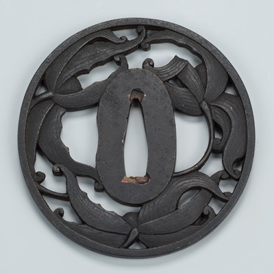 Lot 1501 - AN IRON SUKASHI TSUBA WITH LILIES