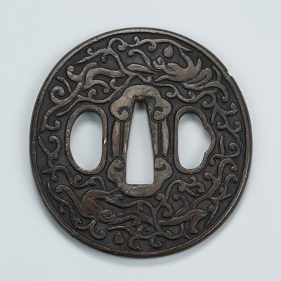 Lot 1502 - A YAMAGANE TSUBA WITH STYLIZED DRAGONS AND VINES