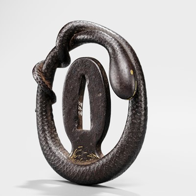 Lot 52 - A RARE IRON MYOCHIN SCHOOL SUKASHI TSUBA IN THE FORM OF A SNAKE