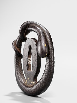 Lot 52 - A RARE IRON MYOCHIN SCHOOL SUKASHI TSUBA IN THE FORM OF A SNAKE