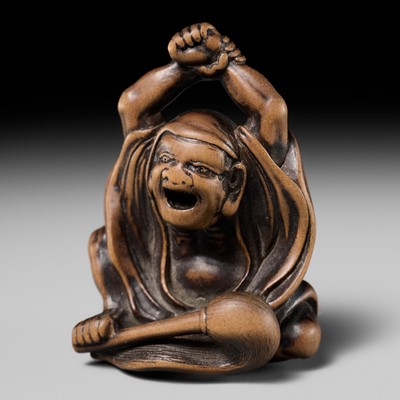 Lot 126 - MASANAO: AN EARLY WOOD NETSUKE OF DARUMA STRETCHING